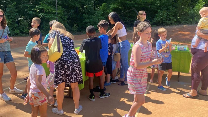 New Matthews students and families enjoy a sand art activity.