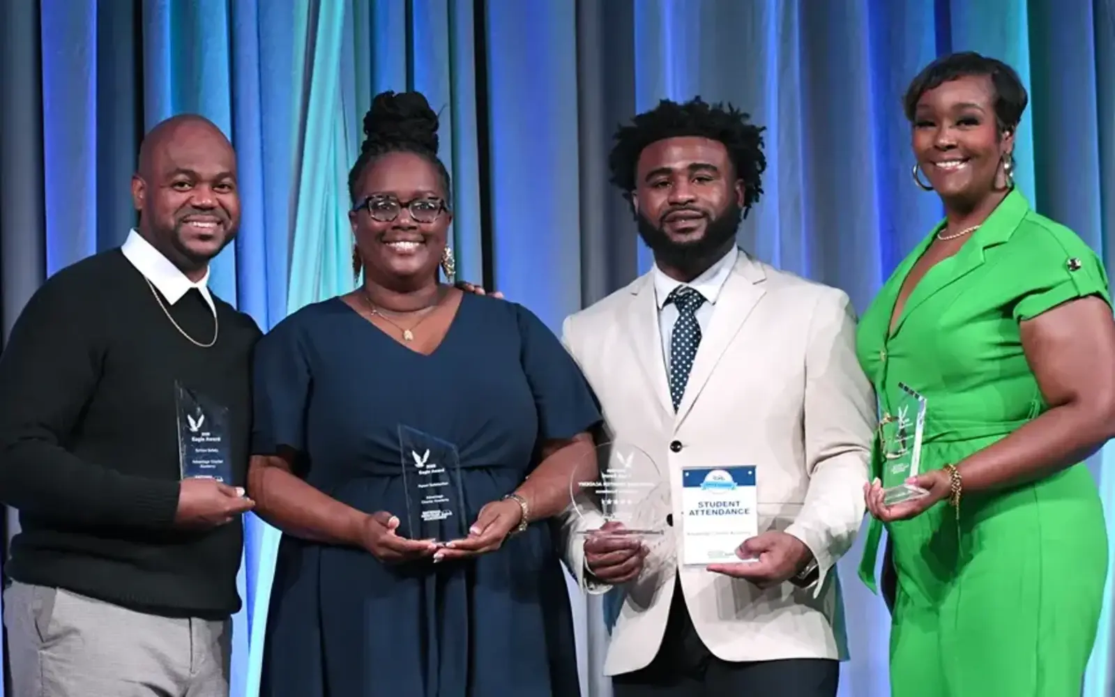 a group of people holding awards