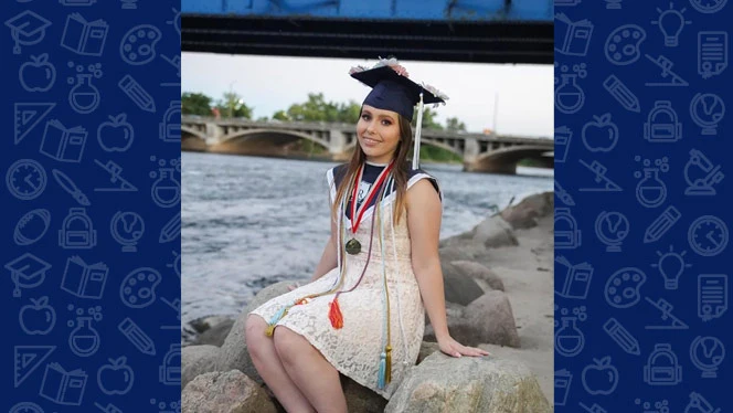 MacKenzie Piper sitting on a rock smiling. MacKenzie Piper sitting on a rock smiling.