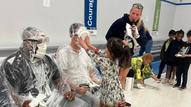 Student pieing staff in face