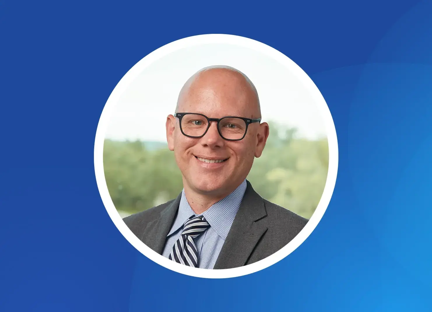 a man wearing glasses and a suit