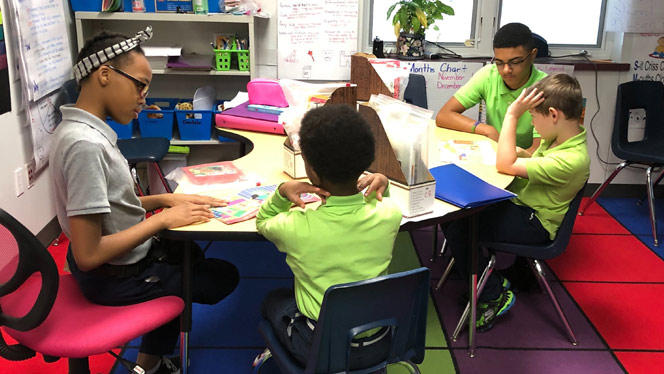Students writing at a table