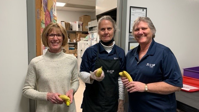 Women holding bananas.