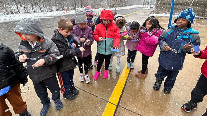 Students measuring snowflakes.