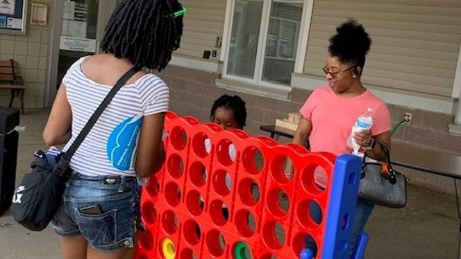 Family playing Connect Four.