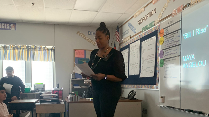 Teacher Elonda Watson recites a poem