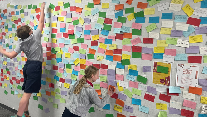 Students adding to the affirmation wall.
