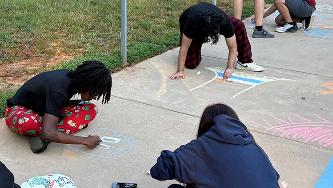 K-12 School in High Point: Phoenix Academy seniors decorate elementary and middle school buildings to help ease young scholars first day of school jitters.