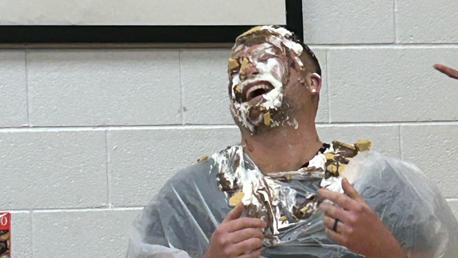 Staff member with pie on his face.