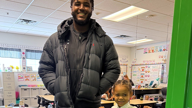 K-8 School in Ypsilanti: EMU football players visited East Arbor students.