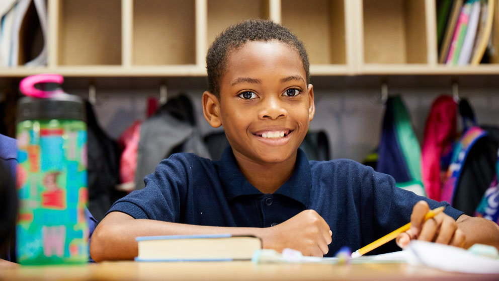 Student raising hand in class