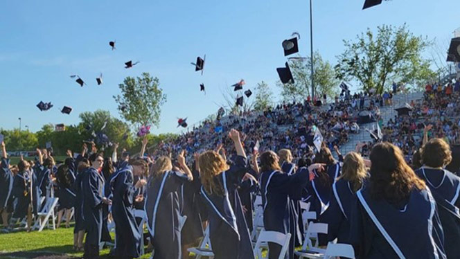 Graduates throwing their caps.
