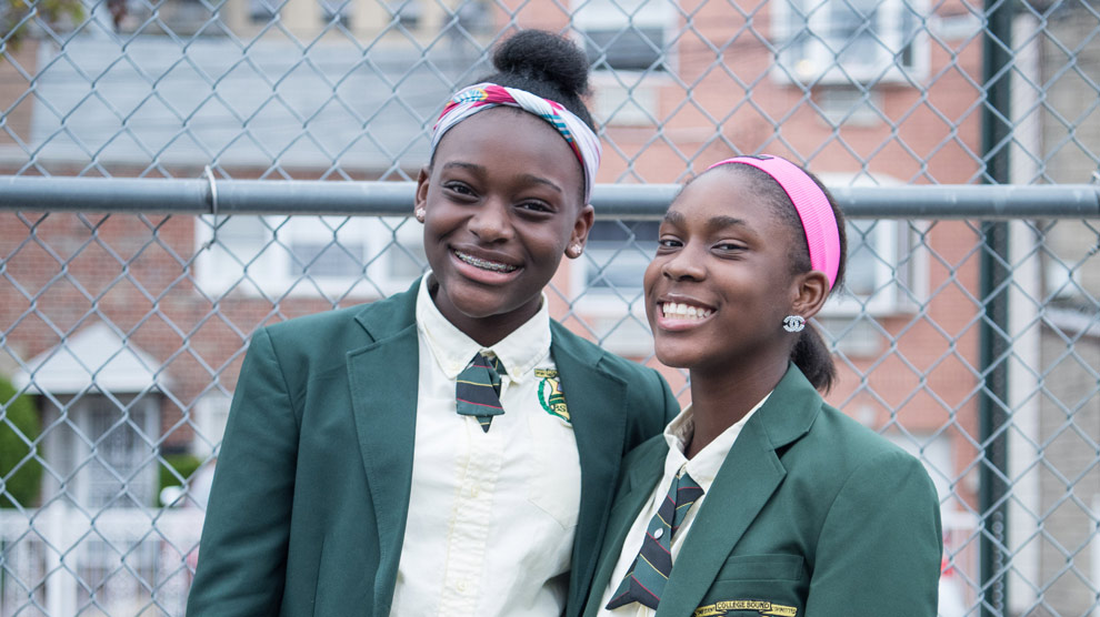 Two students smiling