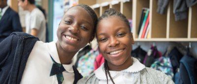 Brooklyn Dreams Charter School, K-8 School in Brooklyn, NY: two students standing together and smiling.
