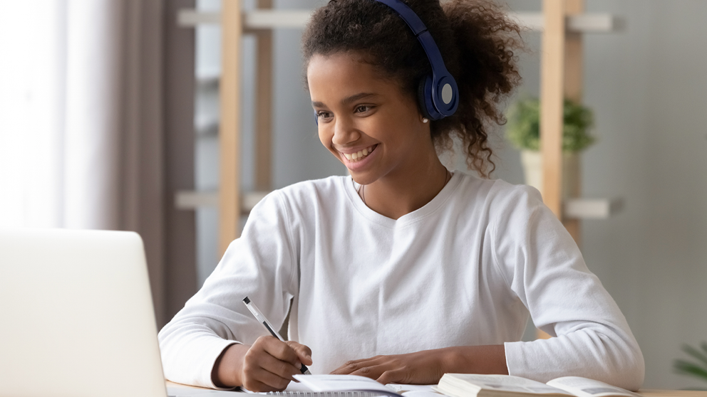 Student working on assignment with virtual teacher