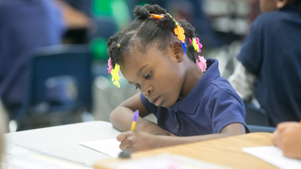 Teacher helping student