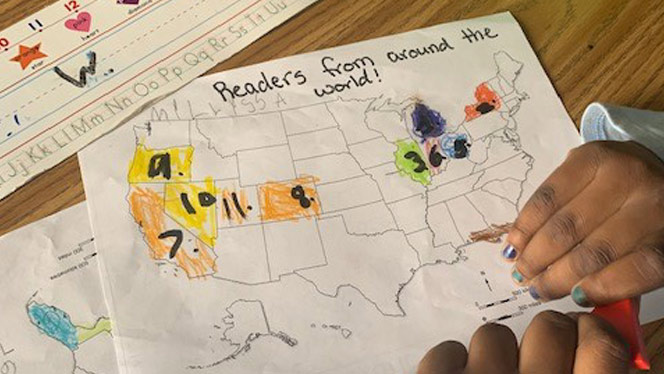 Detroit Merit student coloring a USA map