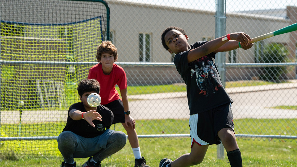 Student playing baseball