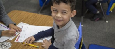 Student completing work in classroom