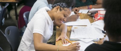 Student completing work in classroom