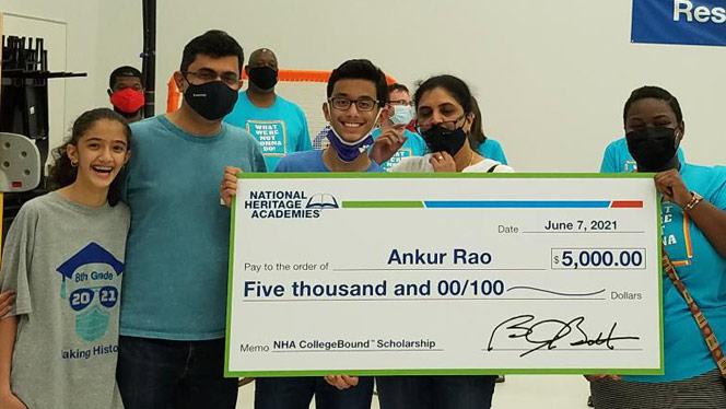 Ankur Rao holding his scholarship.