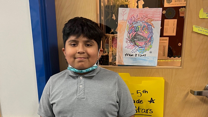East Arbor student with gratitude poster