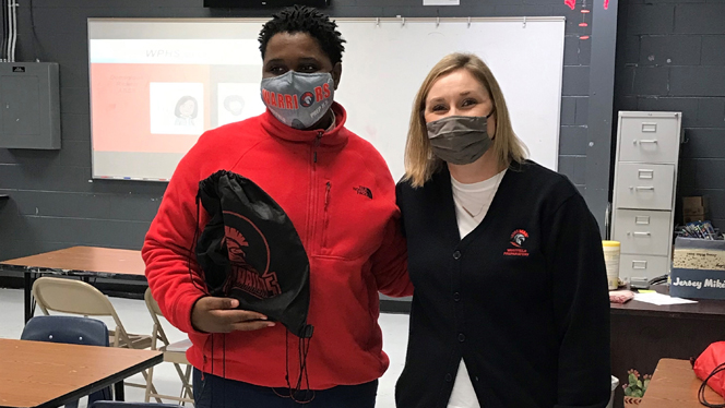 Dean Rachal Hetzel posing with a student