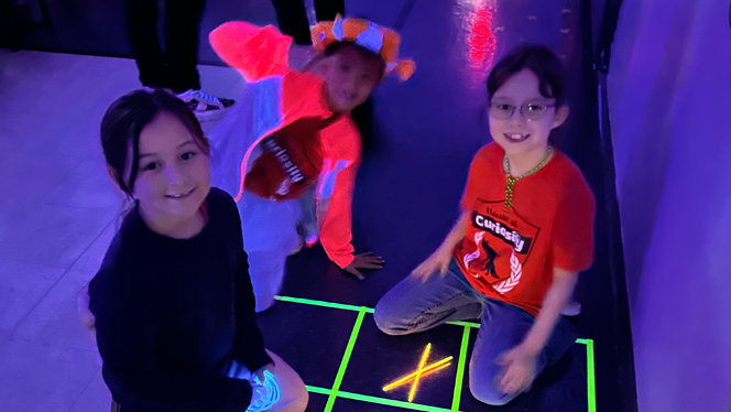 Students playing glow games.