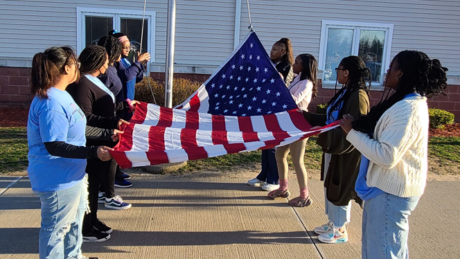Students attaching the flag.