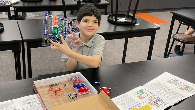 Summit Creek Circuit Club student shows off the completed project he created.
