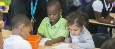 Teacher helps students complete work