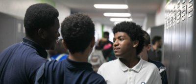 Students interacting in hallway
