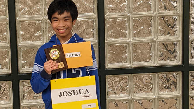 Josh Diocares wins first place in spelling bee.