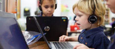 Three students completing work