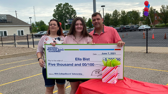 Ella Bist holding a large $5,000 check