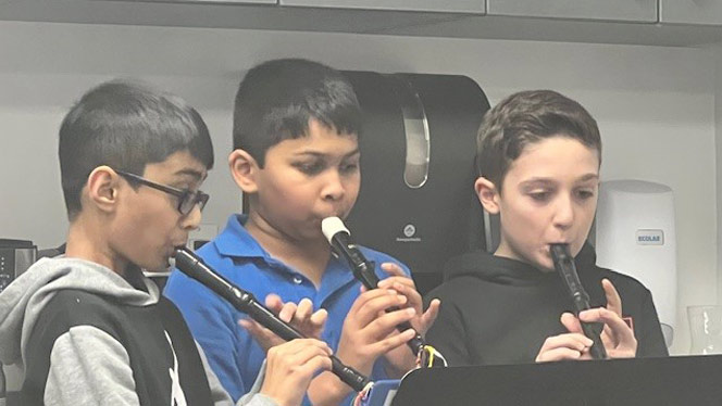 Students playing mini-recorders