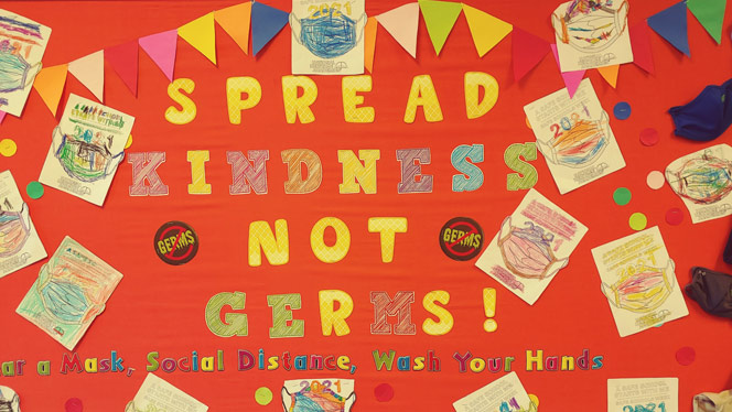 Cutout of paper that reads Spread Kindness Not Germs.