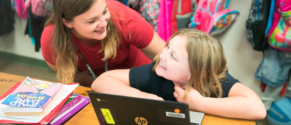 Teacher helping student