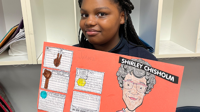 Student showing her Black History Month project.