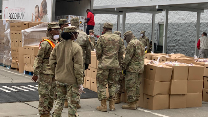 national guard soldiers help hand out food