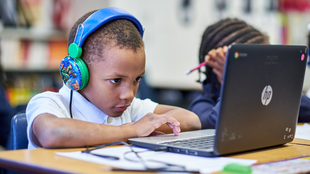 Boy working on laptop