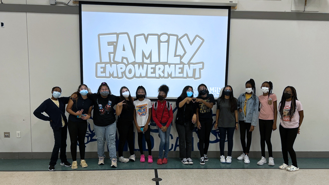 Class standing in front of a screen that says Family Empowerment.