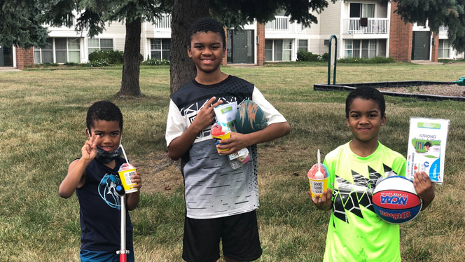 Students enjoying snow cones and smiling