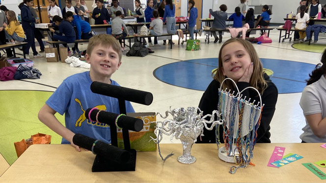 Two students are set up at their shops for Market Day