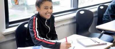 Student completing work in classroom