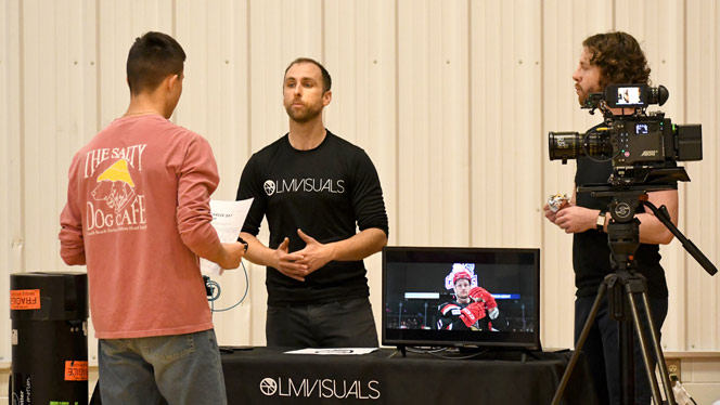 Wellspring Prep student talks to LM Visuals employees.