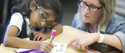 Teacher helping student complete work