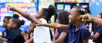 Atlanta Heights Charter School, K-8 School in Atlanta, GA: group of students holding up hands.
