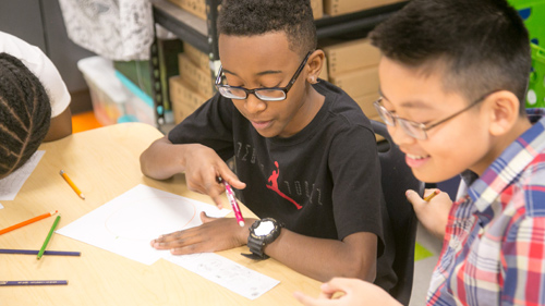 Student raising hand in class