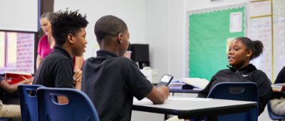 K-8 School in E. Cleveland: Students working in a group, using a calculator.